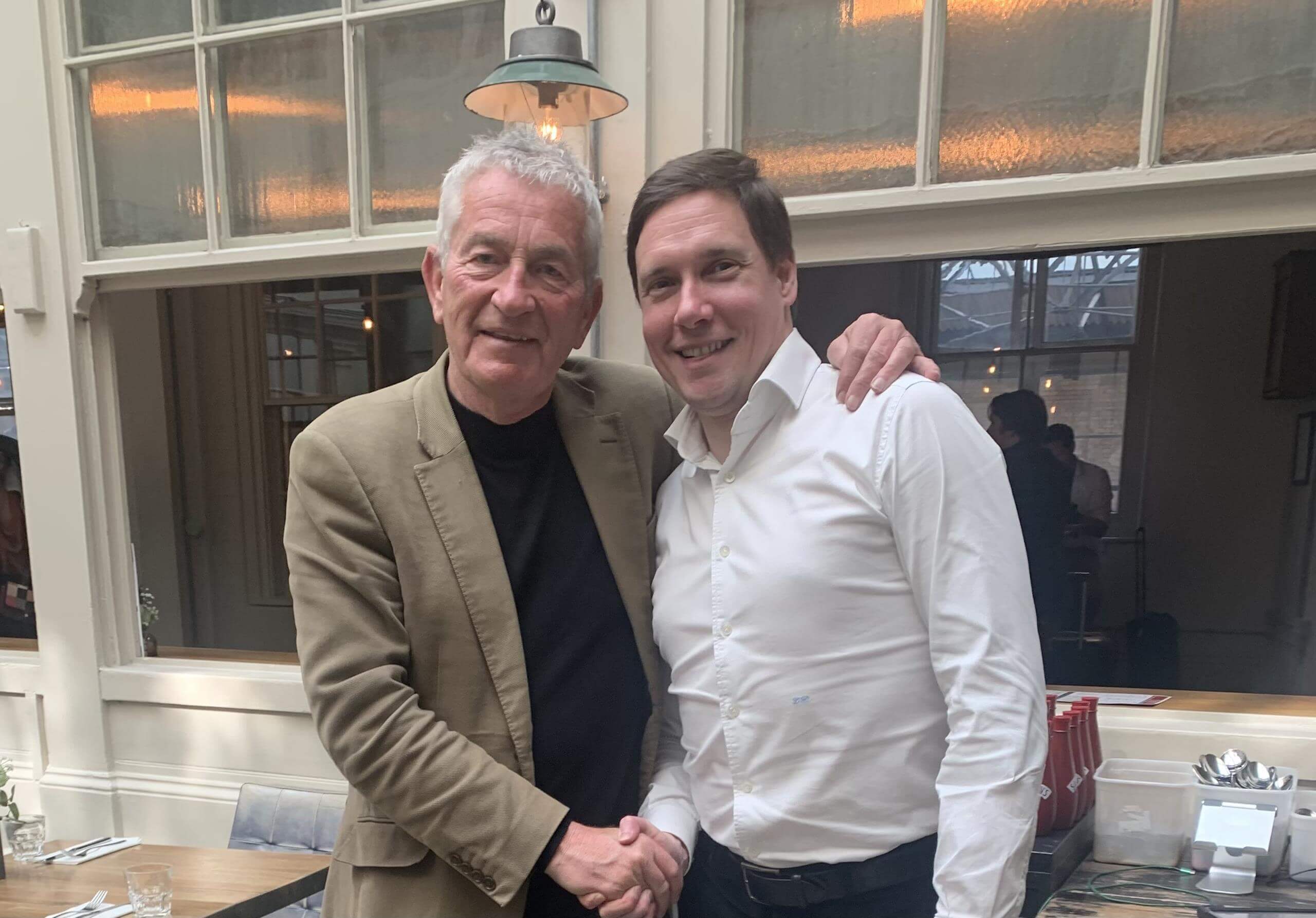 Breaking New Ground and New Markets Two men shaking hands